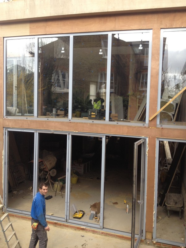 Aluminium bi-fold doors with two-storey glazing in East Molesey